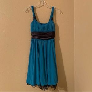 Girl’s green layered dress with black waist ribbon